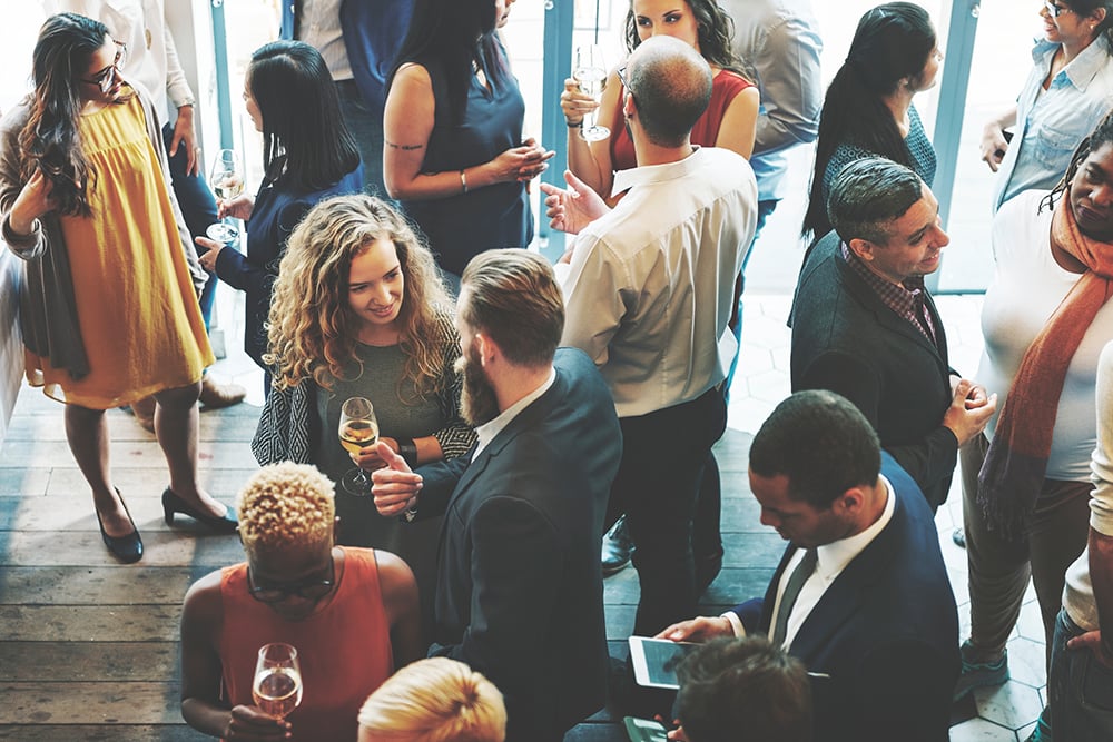 People standing in a large room at a work reception