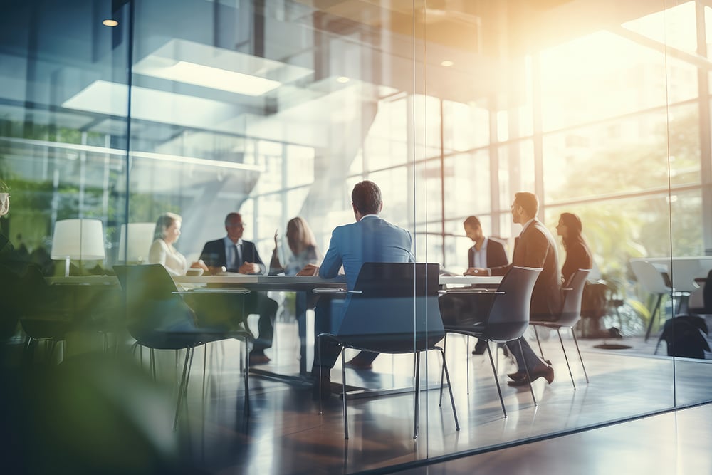 Group of people in a meeting room, with light shining in
