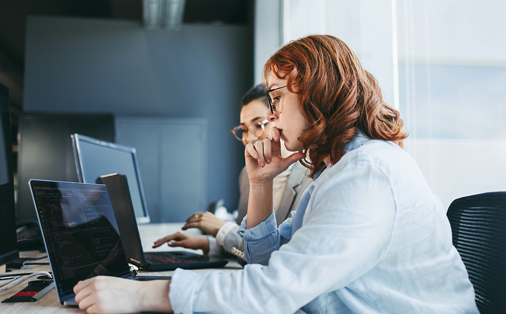 Woman sitting at a meeting table with other people