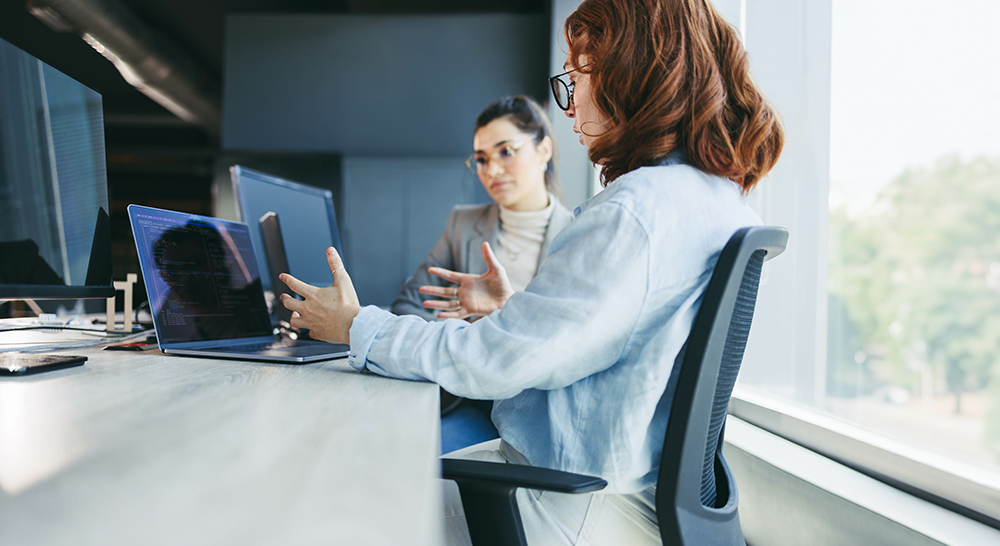 Woman setting at table in meeting room
