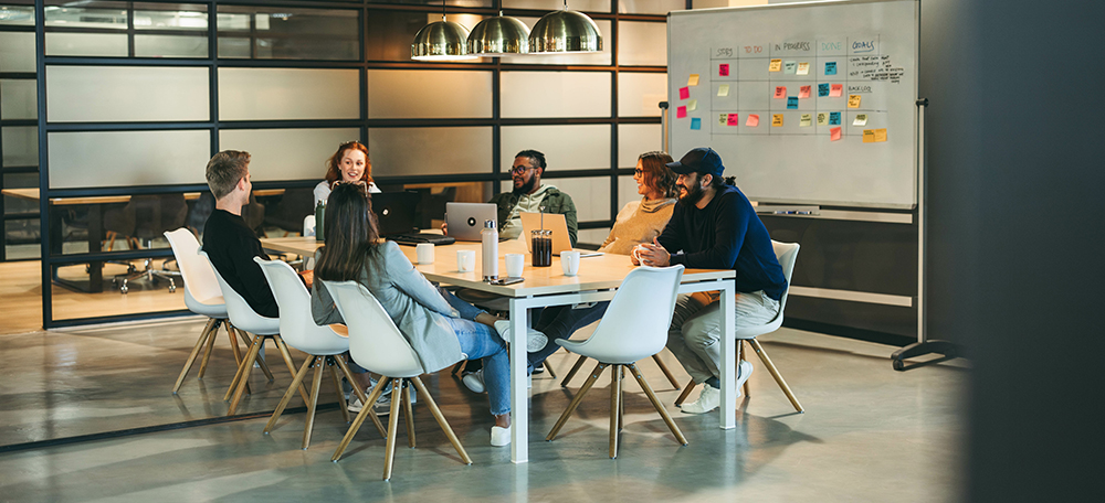 People sitting at a meeting table in a meeting room
