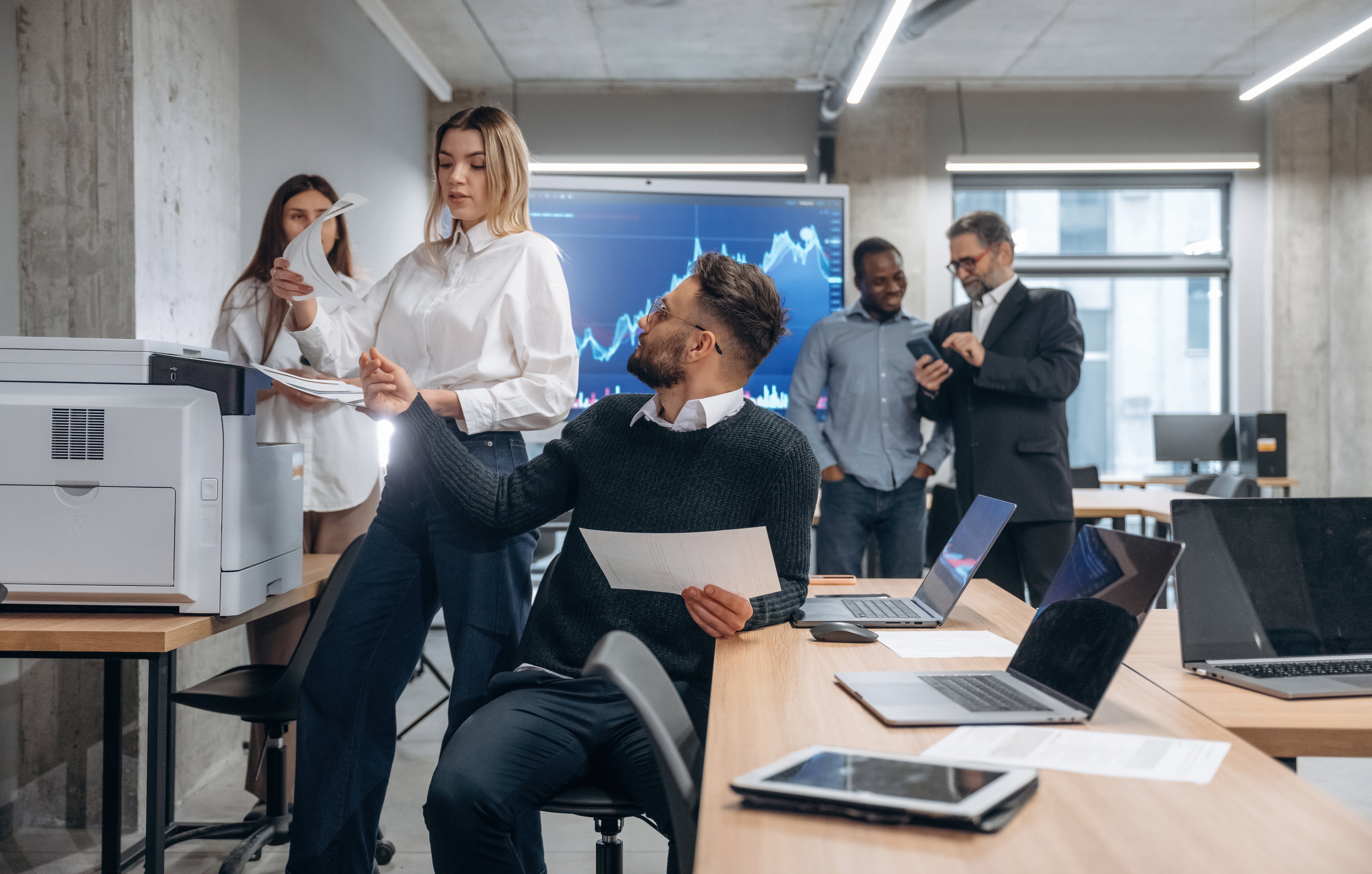 People sitting at a meeting room in a office chatting and laughing