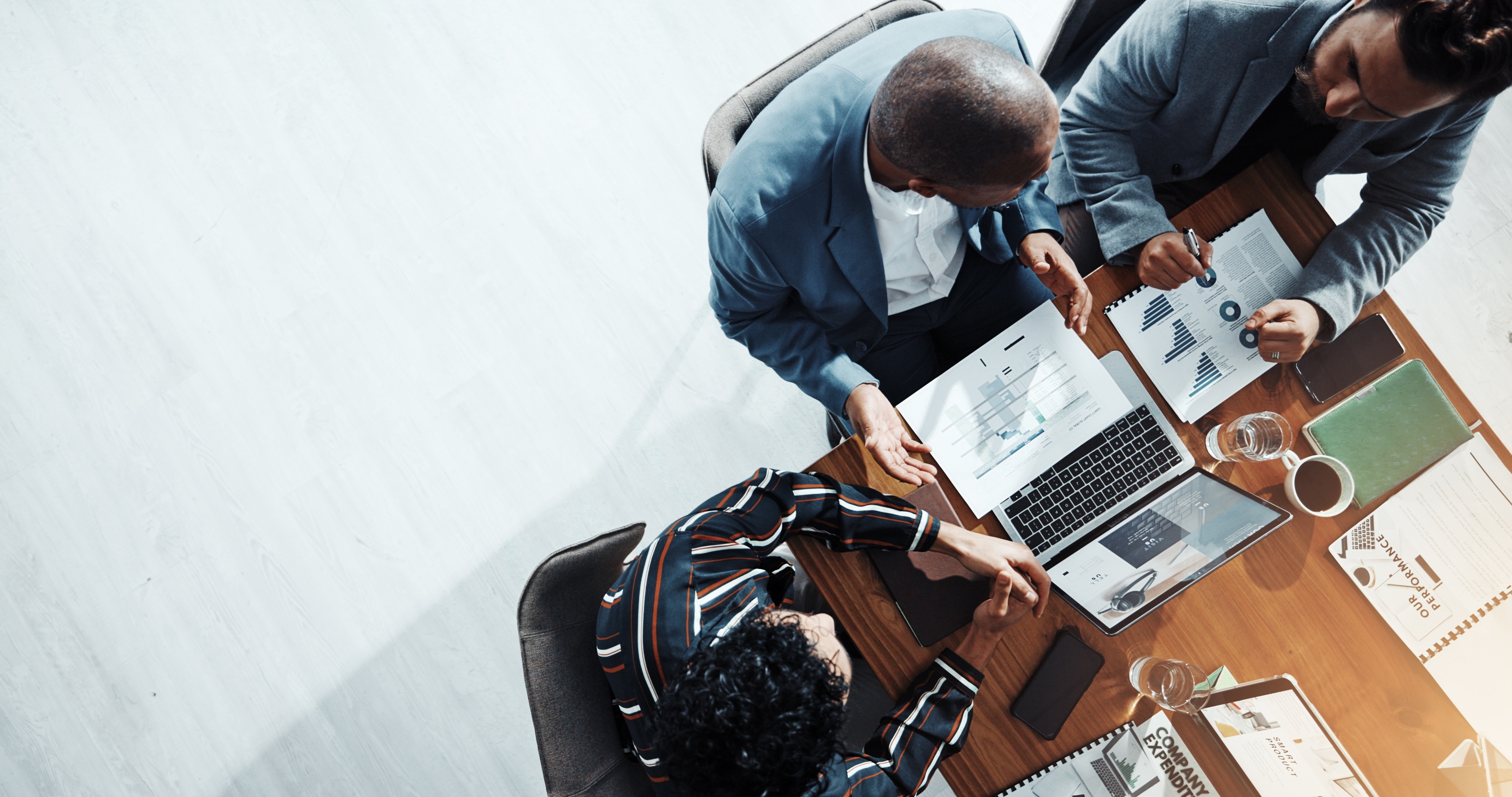 People sitting at a table looking at a laptop