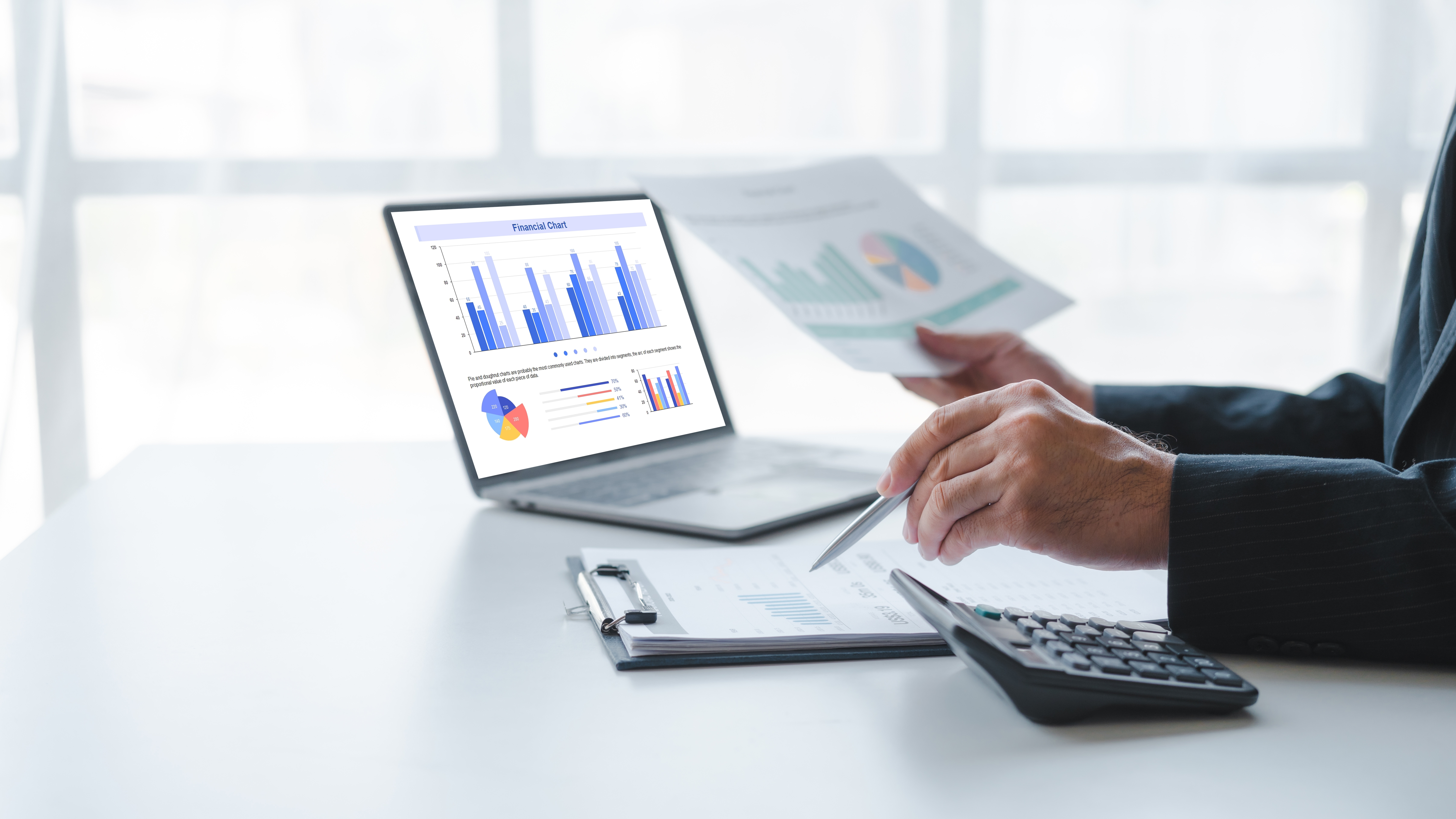 Person at a desk with a laptop looking at a report